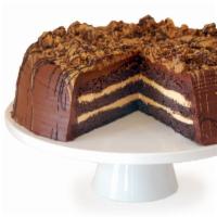 Chocolate Peanut Butter Drizzle Cake · Chocolate cake with a creamy peanut butter filling is topped with fudge and chunks of peanut...