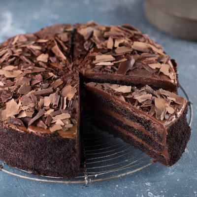Chocolate Fudge Cake · Alternating layers of rich fudgy cake and smooth chocolate butter cream, covered with chocolate shavings.