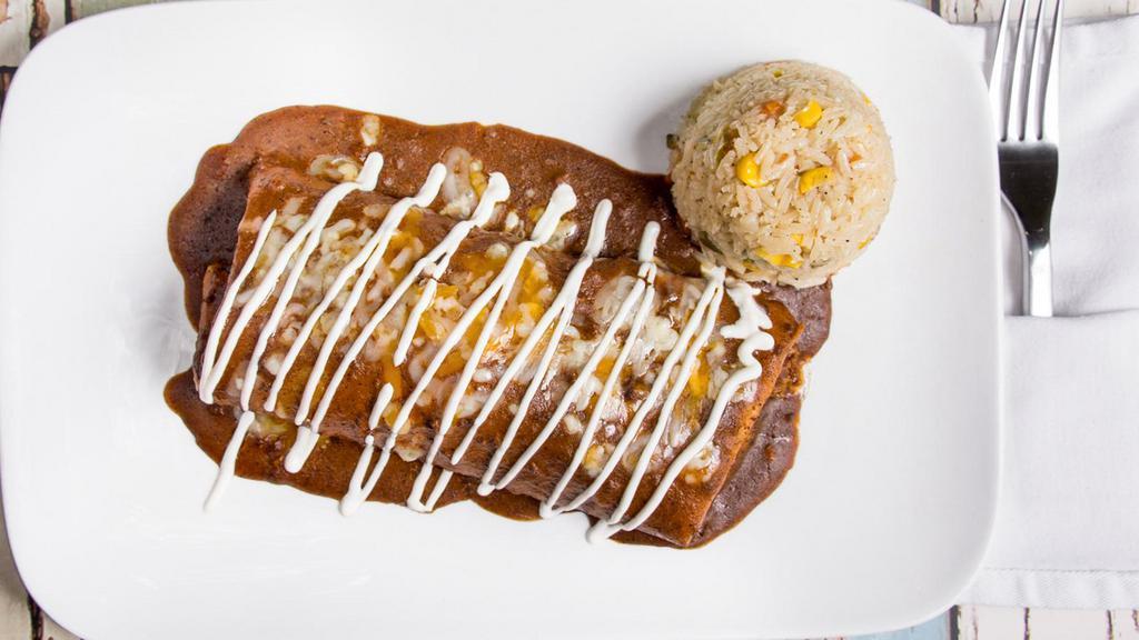 Tiago Burrito · Flour tortilla stuffed with ground beef, refried beans, queso Blanco, signature chili gravy, and cheese on top. Served with Aguirre's rice.