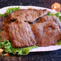 Steak 烤秘制牛排 · Steak with 2 Banchan, 1 Bowl of White Rice, 1 Green Leaf Lettuce, and 1 Sauce.
烤秘制牛排，配有2个韩国小...