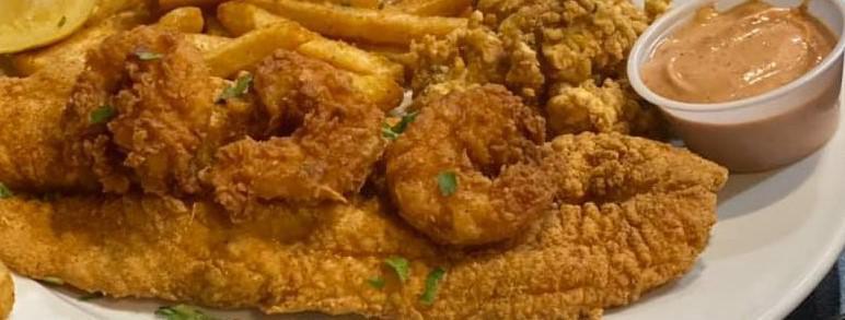Kelands Seafood Platter · Fresh fish, shrimp, and crab balls tossed in our Cajun breaded fried to golden perfection and served with our crispy Cajun fries.