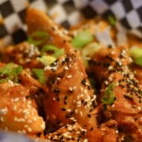 Ninja Coconut Curry Wings · Deep fried wings smothered in our special Ninja Coconut Curry sauce. Topped with green onion...