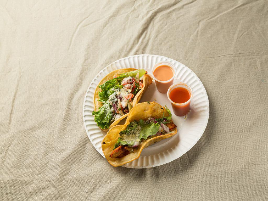 Taco (1pc) · Corn tortilla. Choice of chicken or carnitas. 
Option A: cilantro & onion
Option B: lettuce, tomato    cheese, sour cream
Served with homemade tomatillo avocado sauce.