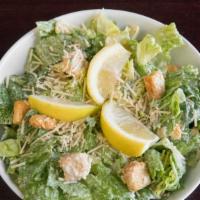 Caesar Salad · Romaine lettuce tossed with Caesar dressing, croutons, lemon and Parmesan cheese. Served wit...