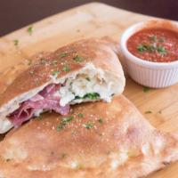 Capone Calzone · House-made meatballs, garlic, roasted red peppers and spinach with pizza sauce, ricotta and ...