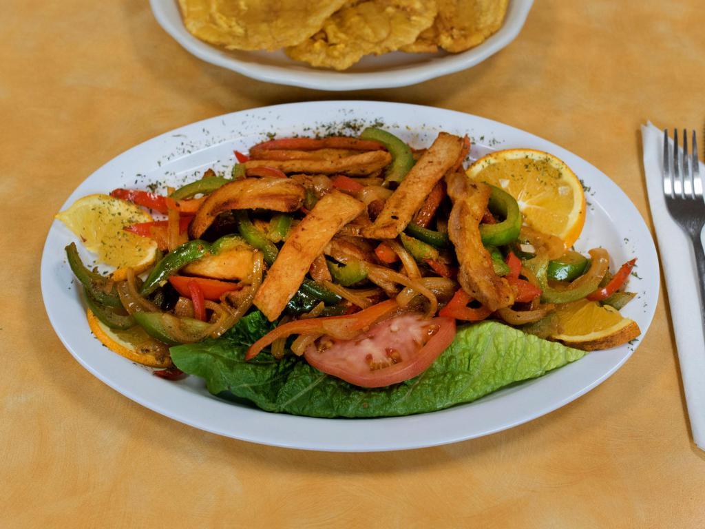 Lomo Salteado · Marinated Pork Loin, Peppers and Onions stir fried and choice of 2 sides.