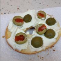 Bagel With Cream Cheese And Olives · 