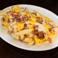 Disco Fries · Regular fries topped with bacon, melted cheddar & mozzarella, and then covered with brown gr...