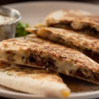 Grilled Steak Quesadilla · A large handmade flour tortilla stuffed with a blend of melted cheese and pico de gallo. Ser...