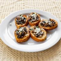 Brushetta with  Funghi · Sliced bread with sauteed mushrooms, parsley and feta cheese.