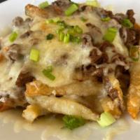 Brisket Poutine · Crispy hand cut fries topped with our Guinness braised brisket, melted white cheddar, brown ...