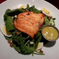 Dill Salmon Salad · Fresh grilled salmon served over spinach with cucumber, onion, hard boiled egg, pralines & o...