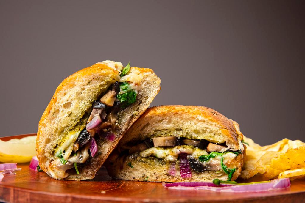 Portobello Sandwich · herb focaccia, pesto, Portobello, balsamic, truffle olive oil, red onions, mozzarella, baby arugula
