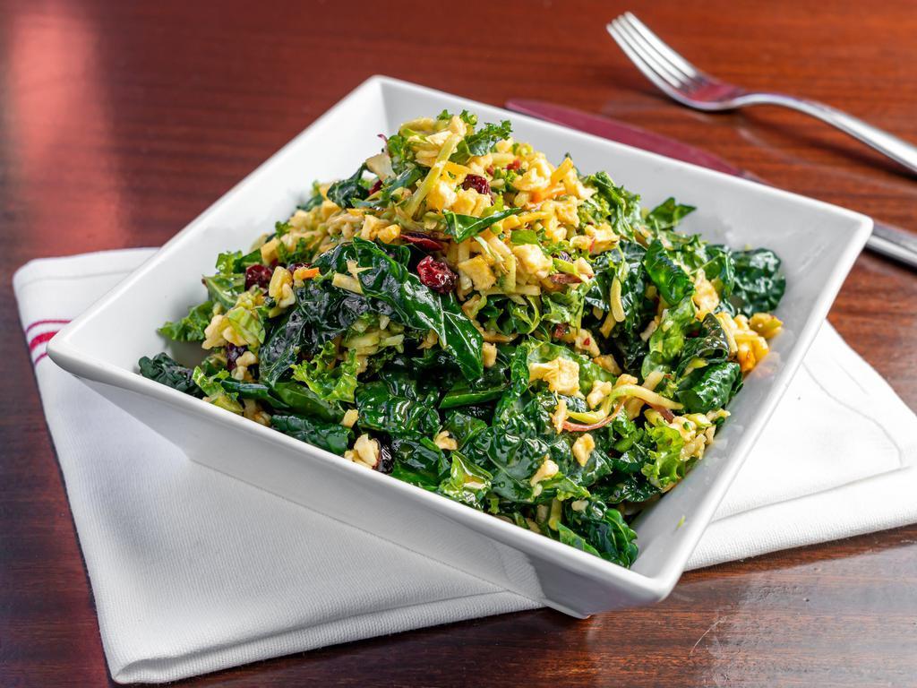 Carroll Gardens Winter Salad · Shaved cabbage and lacinato kale with grated cauliflower, shredded carrots, dried cranberries and apples in a blood orange vinaigrette.