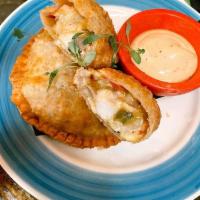Chicken and Cheese Fajita Empanada · Marinated chicken Grilled peppers and onions, shredded cheese