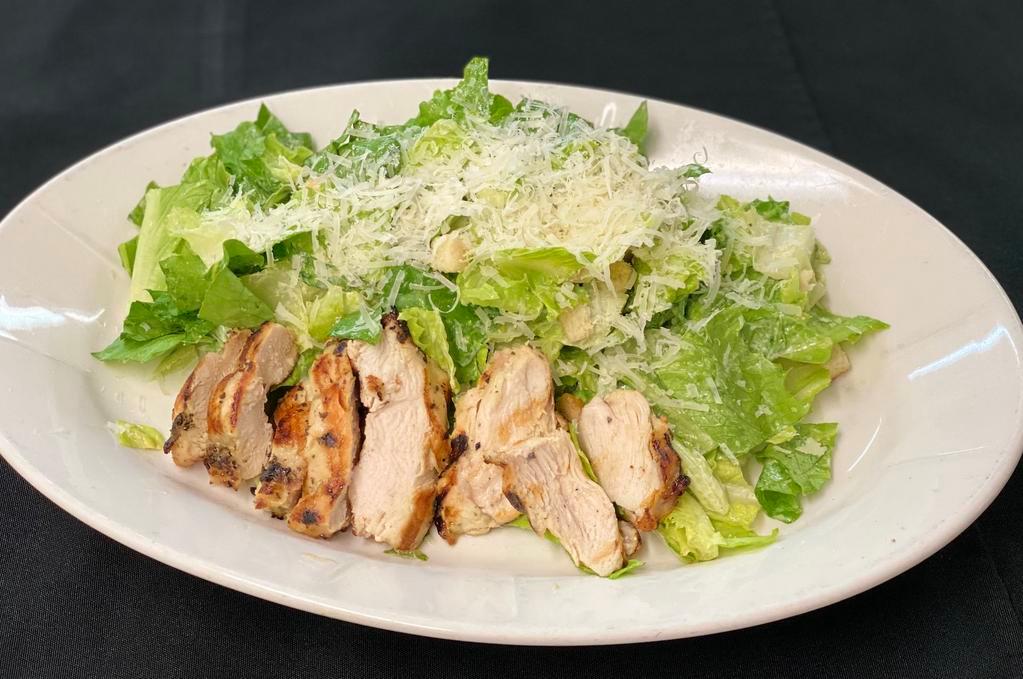 Chicken Caesar Salad  · Grilled lemon marinated chicken breast, crisp romaine lettuce, shaved Parmesan, croutons, house Caesar dressing.