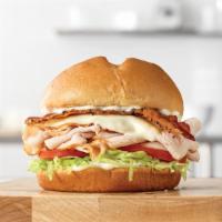 Grand Turkey Club · Hot thinly sliced turkey with melted Swiss cheese, pepper bacon, lettuce and tomato and mayo...