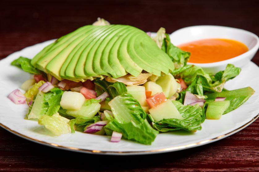 Avocado Salad · Avocado, tomatoes, cucumbers, lettuce, carrots and peppers topped with salad dressing.