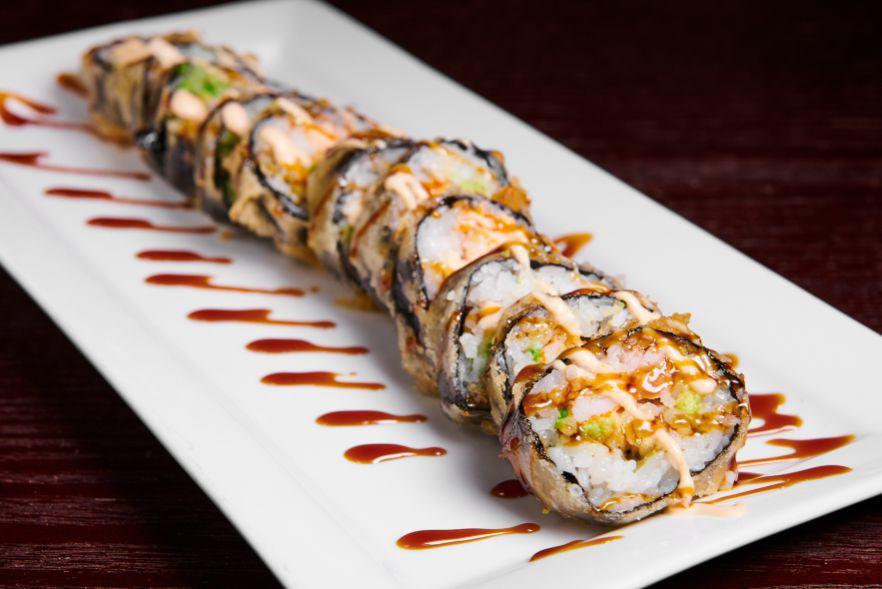 Godzilla Roll · Tuna, salmon, kani and avocado, topped with spicy mayo,sweet sauce and masago.