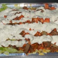 Spicy Mix Over Rice Chicken and Lamb with Free Can Soda · Mixed spicy grilled chicken and lamb served with lettuce, tomatoes, and cucumbers topped wit...