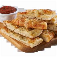 Cheezy Sticks · Ten pieces of freshly baked bread covered with cheese and topped with spices.