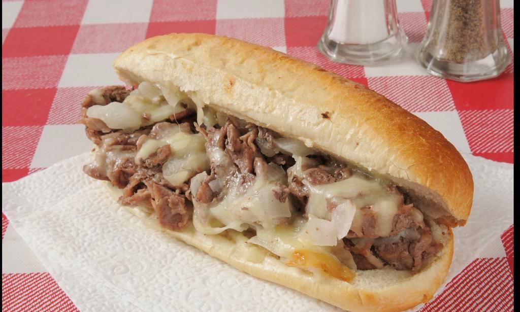 Philly Cheesesteak · Philly Cheesesteak with tender ribeye steak, melted gooey provolone, and caramelized onions hugged by a toasted garlic butter hoagie roll. This is the classic way to make a Philly Cheesesteak sandwich!