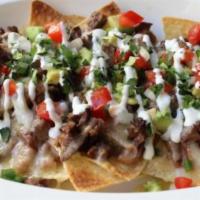 Steak Loaded Nachos · Folded tortilla with a variety of fillings such as meat or beans. 