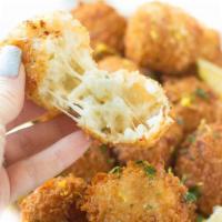 Arancini With Cheese · 2 pieces. Arancini are italian rice balls that are stuffed with mozzarella cheese, coated wi...