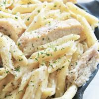 Pasta with Chicken Alfredo · Rigatoni pasta in our house alfredo sauce, garlic, shallots, bacon bits, parmesan cheese and...