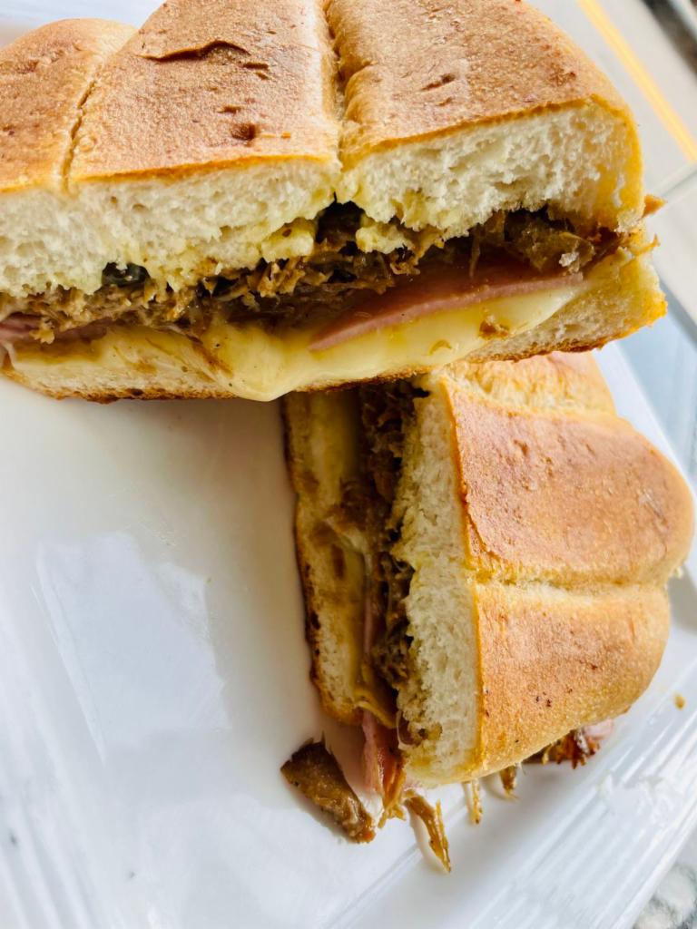 Cuban sandwich  · Roasted pork, smoked ham, Swiss cheese and marinated pickles mustard