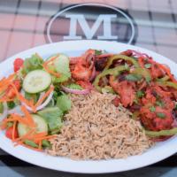Chicken tikka over rice · Served with salad