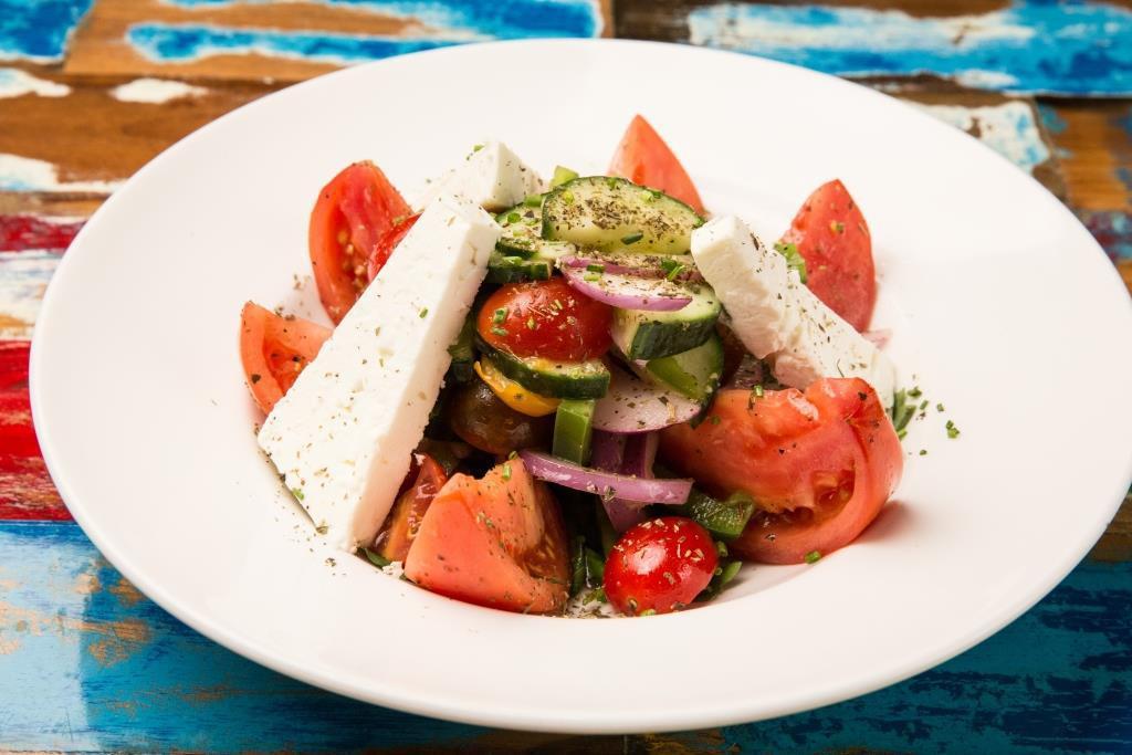 Greek Salad · Tomatoes, Cucumber, Peppers, Onion, Greek Feta, Kalamata Olives, Extra Virgin Olive Oil and Red Wine Vinegar.