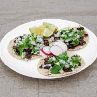 Taco · Corn or flour tortilla with your choice of meat, topped with onions and cilantro.