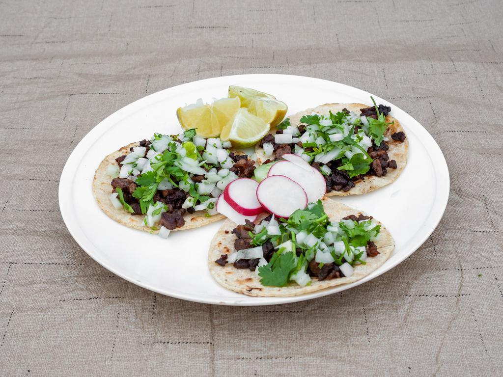 Taco · Corn or flour tortilla with your choice of meat, topped with onions and cilantro.