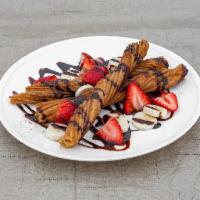 Churro Bites · Served with strawberries, bananas, and chocolate syrup.