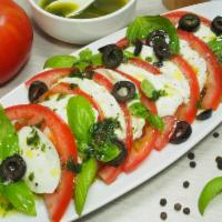 Caprese Salad · Made with fresh mozzarella, sliced fresh plum tomatoes, basil and olive oil.
