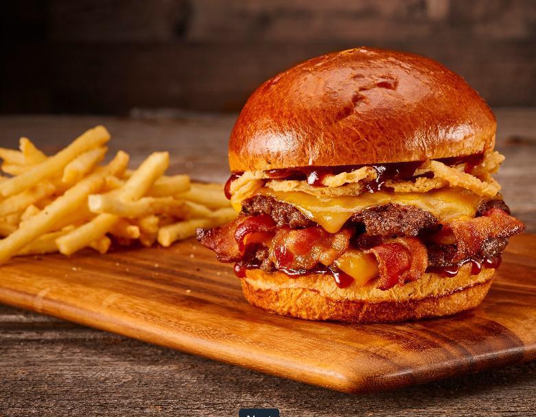 BBQ Bacon Smash · Double smash burger, applewood-smoked bacon, cheddar, fried onion strings and BBQ sauce on a brioche bun.