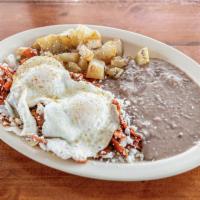 Chilaquiles Rojos · Fresh deep-fried tortillas chips cooked with egg with red sauce and served with refried bean...