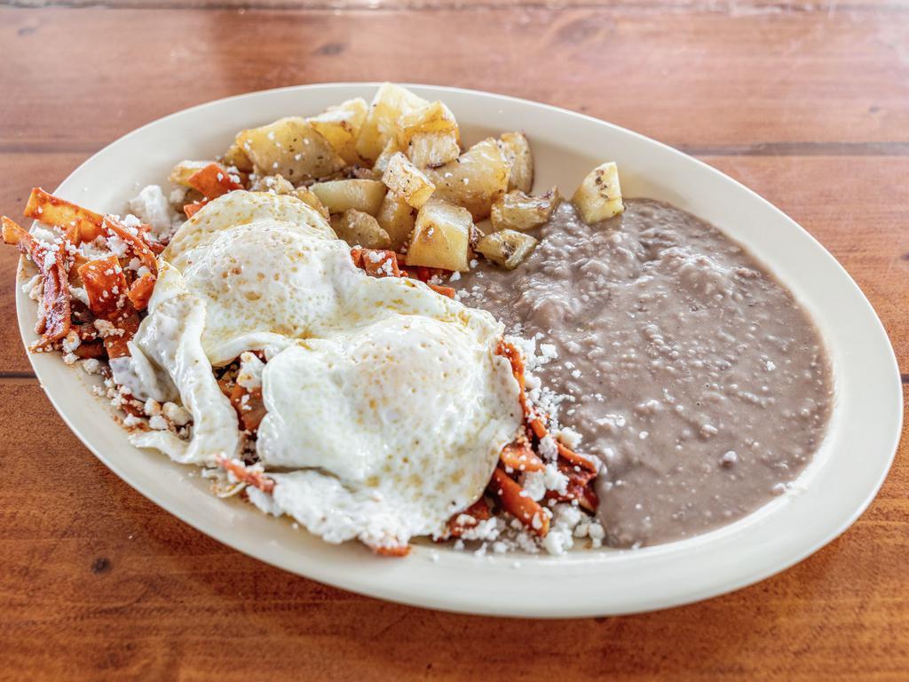Chilaquiles Rojos · Fresh deep-fried tortillas chips cooked with egg with red sauce and served with refried beans and potatoes.