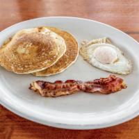 Pancakes · 2 pancakes with 1 egg and 1 strip of bacon. No tortillas on this plate.