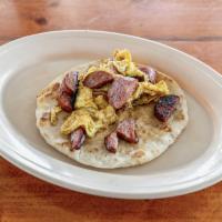 Country and Egg Taco · Folded tortilla with a variety of fillings such as meat or beans. 