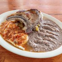 32. Pork Chops Plate · 2 pork chops with ranchero sauce served rice, beans, salad, avocado and 2 tortillas. FREE SO...