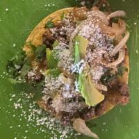 One (1) Taco · Taco is prepared with double corn tortillas, grilled onions, cilantro, avocado, raw onions, ...
