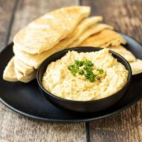 Hummus · A creamy blend of garbanzo beans with tahini garlic, lemon juice, herbs and spices.  