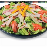 Ultimate Club Salad · Crisp lettuce, ham, turkey, Swiss, cheddar, bacon and tomatoes.