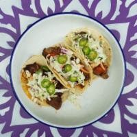Barbacoa Tacos · adobo-braised beef, salsa roja, onion, cilantro, radish