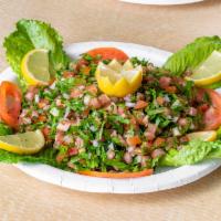 Tabbouleh Salad · Chopped parsley, diced tomato, onion, mint and crushed wheat (Burghul) with fresh lemon juic...
