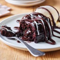 Triple Chocolate Meltdown · Warm, Rich, fudge filled chocolate cake drizzled with hot fudge. Served with vanilla ice cre...