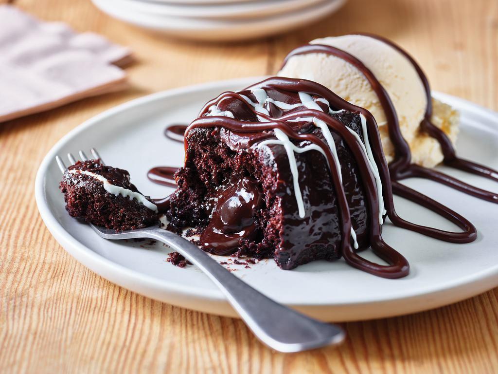 Triple Chocolate Meltdown · Warm, Rich, fudge filled chocolate cake drizzled with hot fudge. Served with vanilla ice cream.