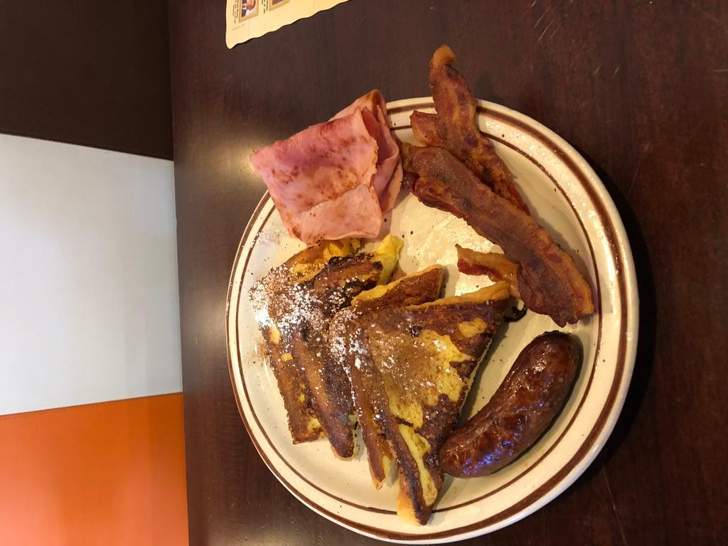 French Toast Deluxe · Served with ham, bacon and sausage.